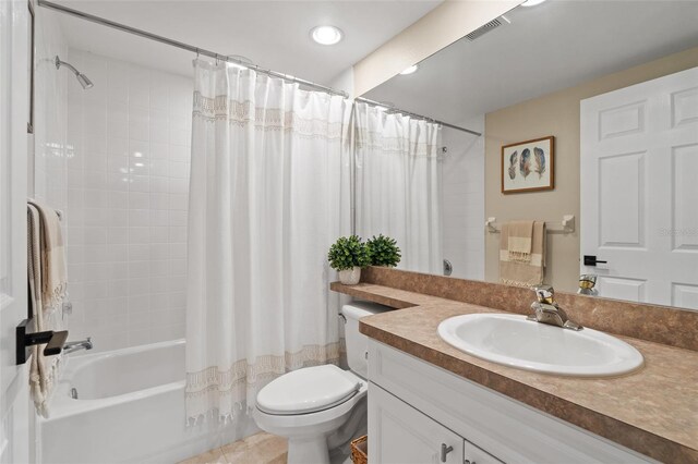 full bathroom with toilet, vanity, tile patterned floors, and shower / tub combo