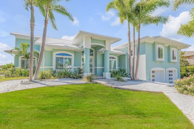 view of front of property featuring a garage and a front lawn