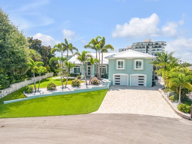 view of front of home with a front lawn and a garage