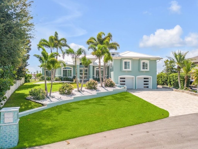 view of front of home featuring a garage and a front lawn