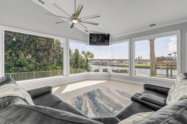 living room with ceiling fan, a wealth of natural light, crown molding, and vaulted ceiling