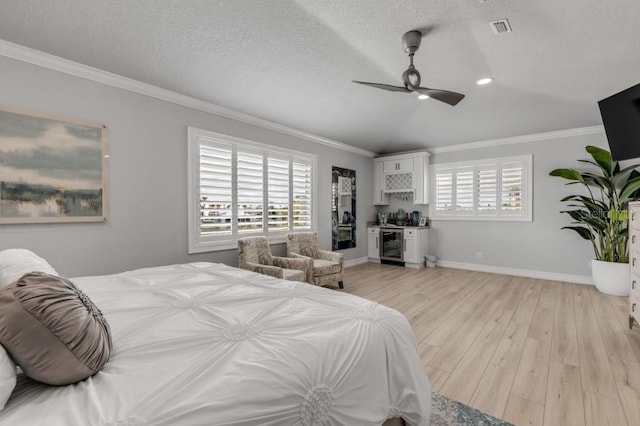 bedroom featuring multiple windows, ceiling fan, wine cooler, and light hardwood / wood-style flooring