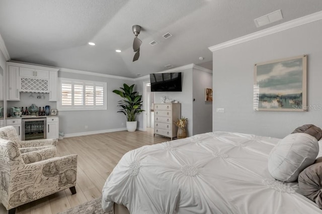 bedroom with light wood-type flooring, bar area, wine cooler, ceiling fan, and lofted ceiling