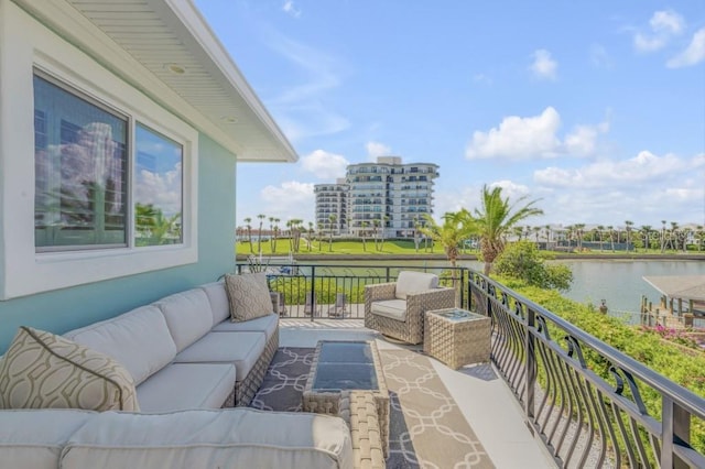 balcony featuring a water view and an outdoor hangout area