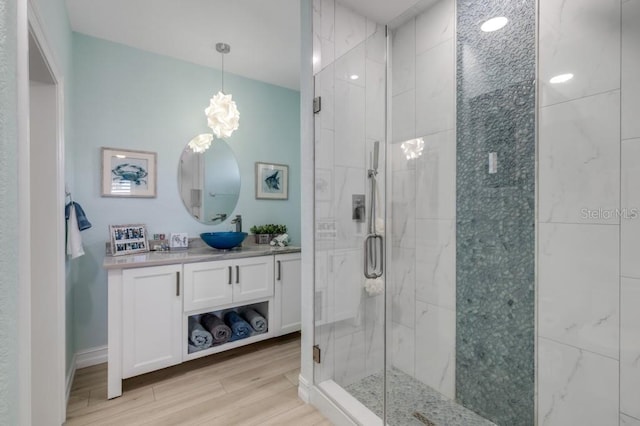 bathroom featuring vanity, hardwood / wood-style flooring, and walk in shower