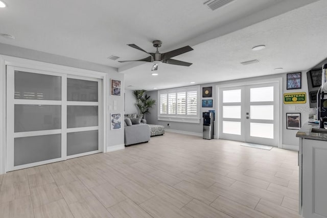 unfurnished living room featuring ceiling fan