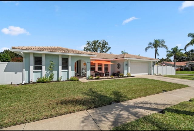 view of front of property featuring a garage and a front lawn