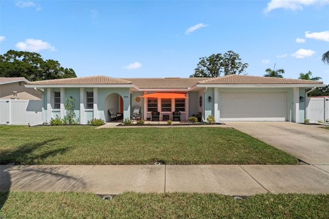 view of front of property with a garage and a front lawn