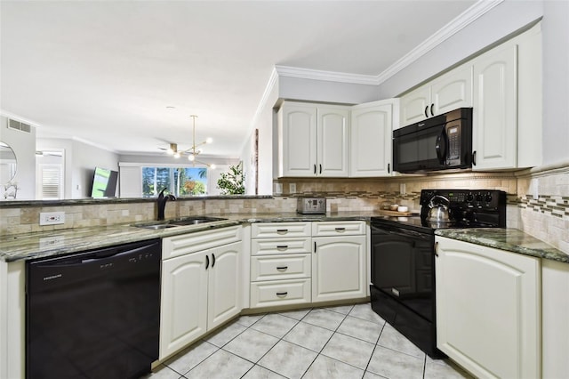 kitchen featuring dark stone countertops, white cabinetry, black appliances, sink, and light tile patterned flooring