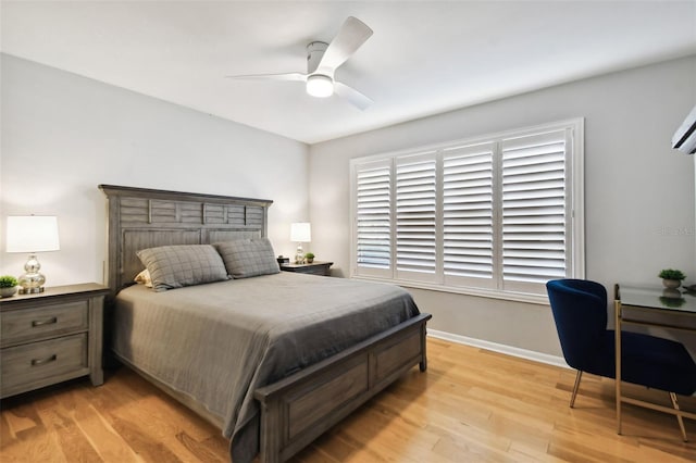 bedroom with ceiling fan and light hardwood / wood-style floors