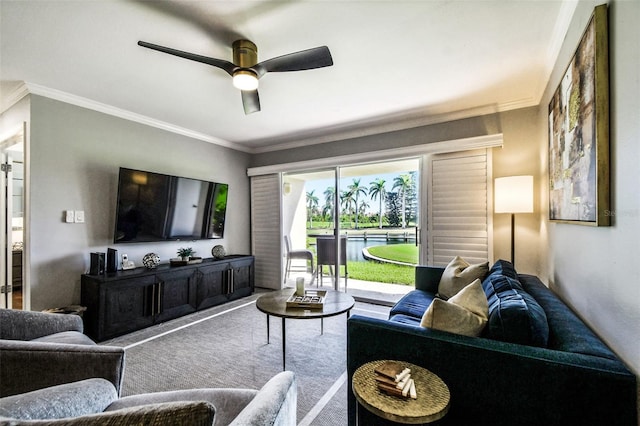 living room featuring ceiling fan, carpet, and ornamental molding