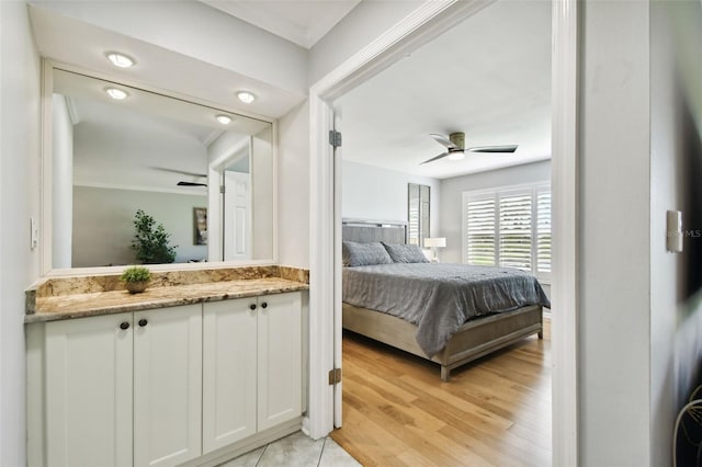 bedroom with ceiling fan, light hardwood / wood-style floors, and ornamental molding