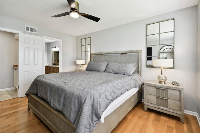 bedroom with ceiling fan, ensuite bathroom, and light hardwood / wood-style floors