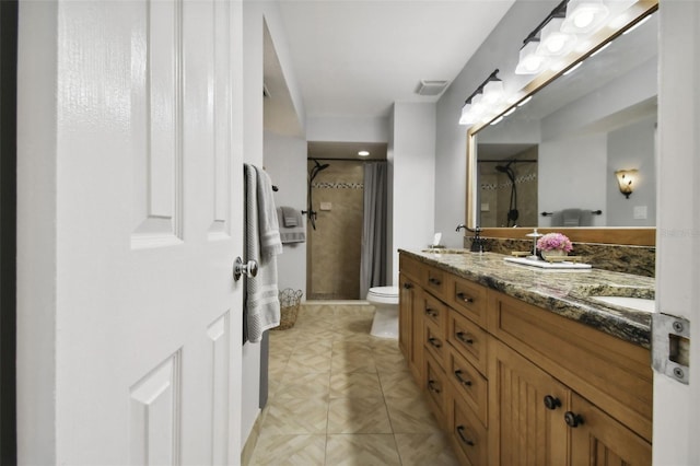 bathroom featuring vanity, toilet, and a shower with shower curtain