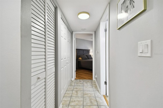 hall featuring light tile patterned flooring