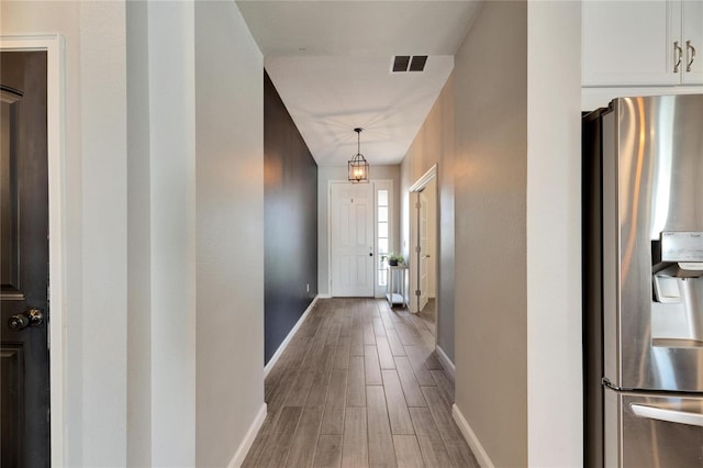 hallway featuring wood-type flooring