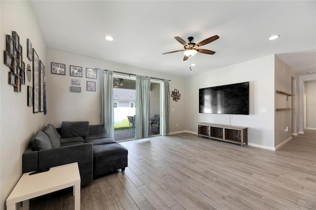 living room with hardwood / wood-style floors and ceiling fan