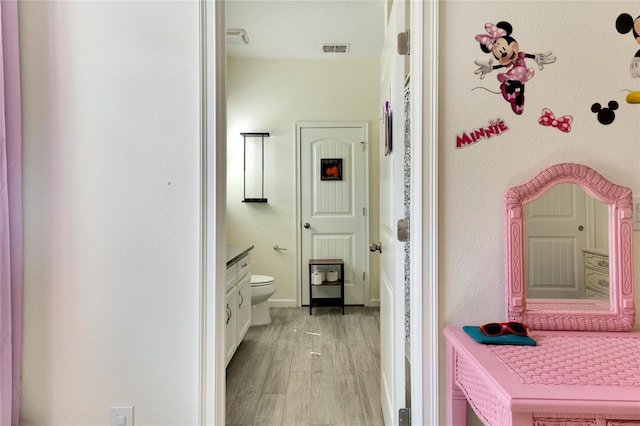 bathroom featuring hardwood / wood-style floors, toilet, and vanity