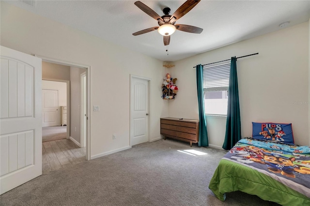 bedroom featuring ceiling fan and light carpet