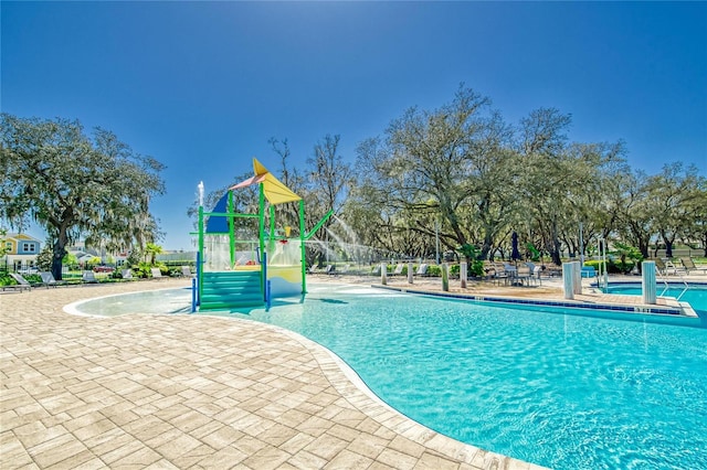 view of swimming pool with a playground