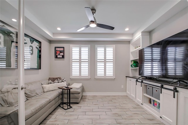 living room featuring ceiling fan and light hardwood / wood-style flooring