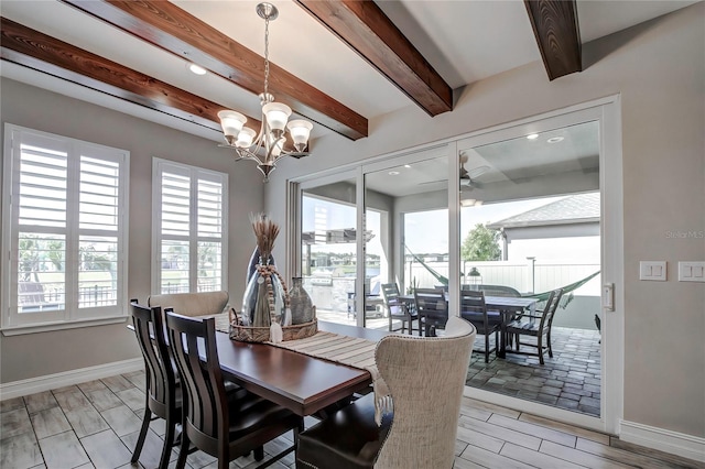 dining area featuring beamed ceiling, ceiling fan with notable chandelier, and light hardwood / wood-style floors