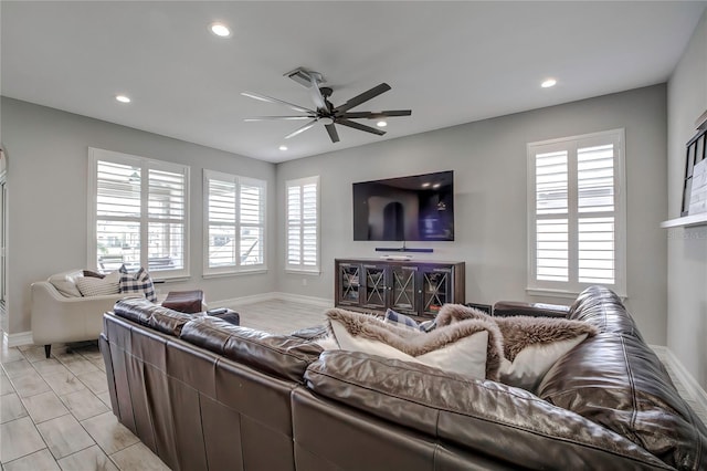 living room with ceiling fan and a healthy amount of sunlight