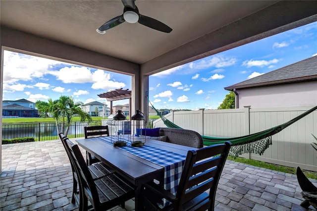 view of patio featuring ceiling fan and a water view