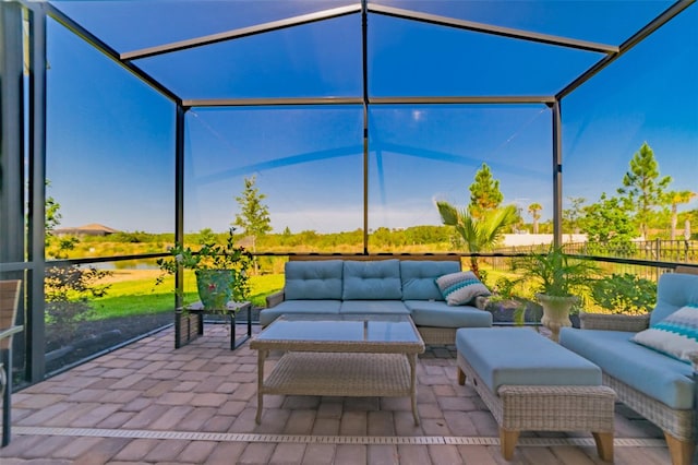 view of patio featuring glass enclosure and outdoor lounge area