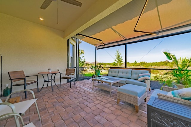 view of patio with outdoor lounge area and ceiling fan