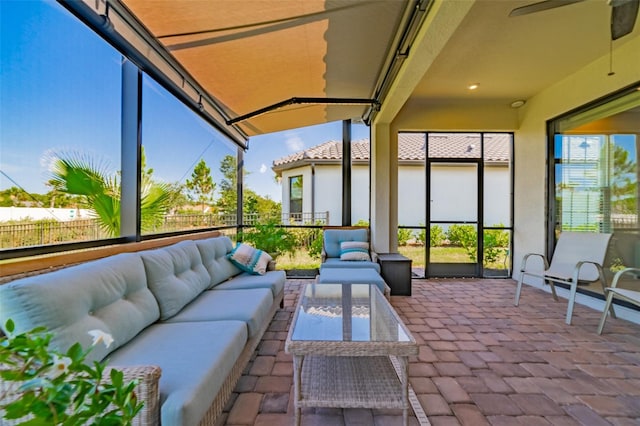 sunroom featuring ceiling fan