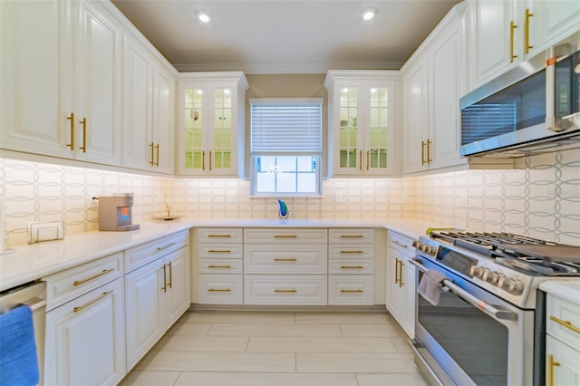 kitchen with stainless steel appliances, backsplash, and white cabinetry