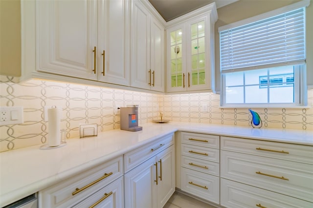 kitchen with decorative backsplash and white cabinets