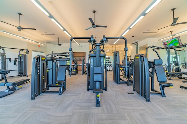 workout area featuring ceiling fan and light colored carpet