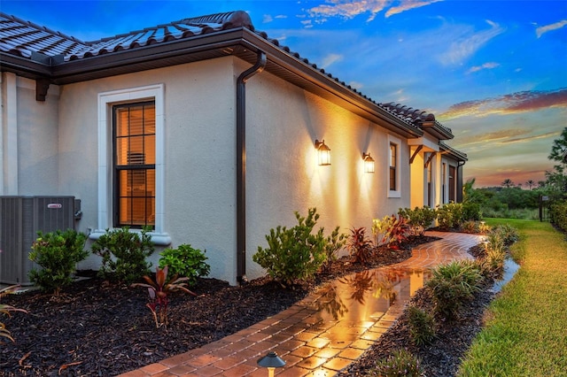 property exterior at dusk with central air condition unit