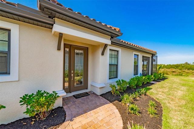 property entrance with a lawn