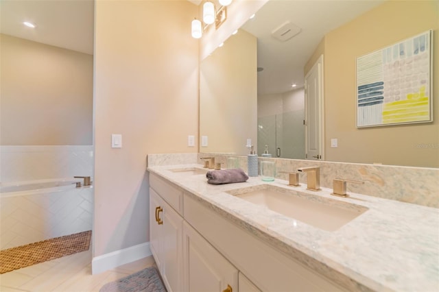 bathroom featuring tile patterned floors, shower with separate bathtub, and vanity