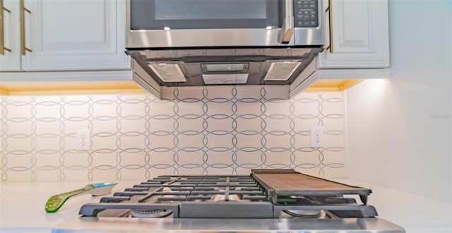 kitchen featuring white cabinets and appliances with stainless steel finishes