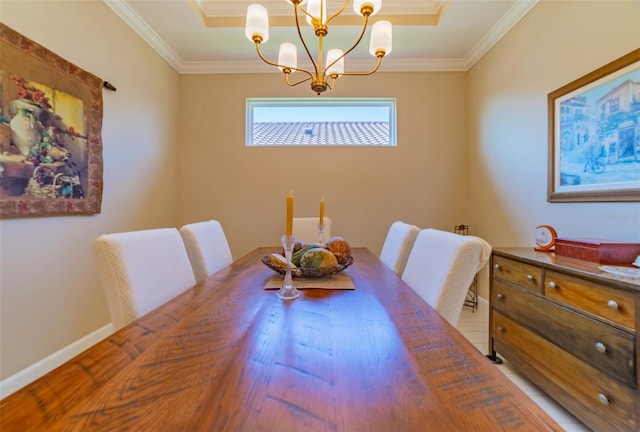 dining space with ornamental molding and a chandelier