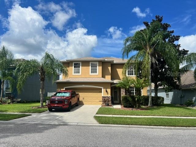 view of front of property featuring a garage and a front lawn