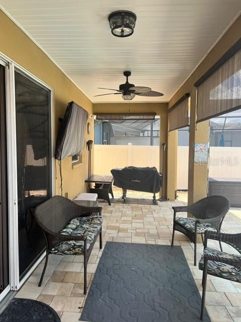 sunroom with ceiling fan