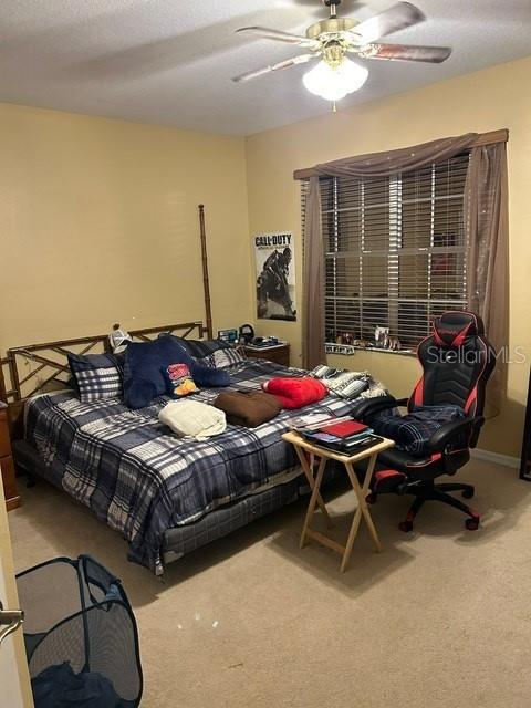 carpeted bedroom with ceiling fan