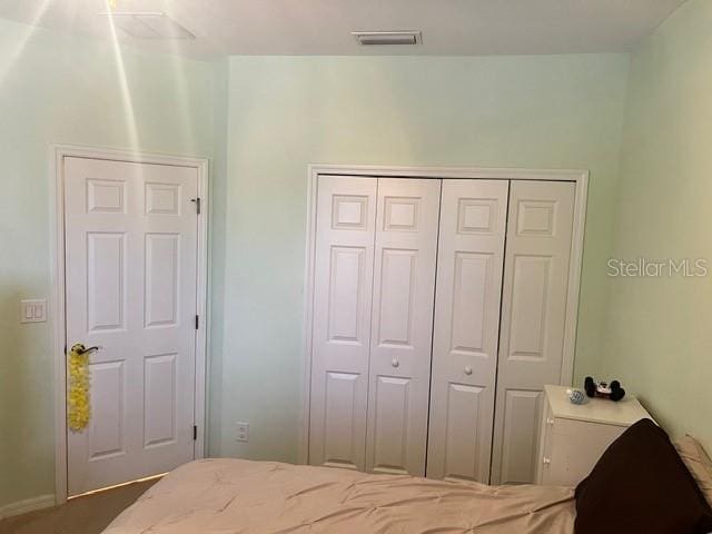 carpeted bedroom featuring a closet