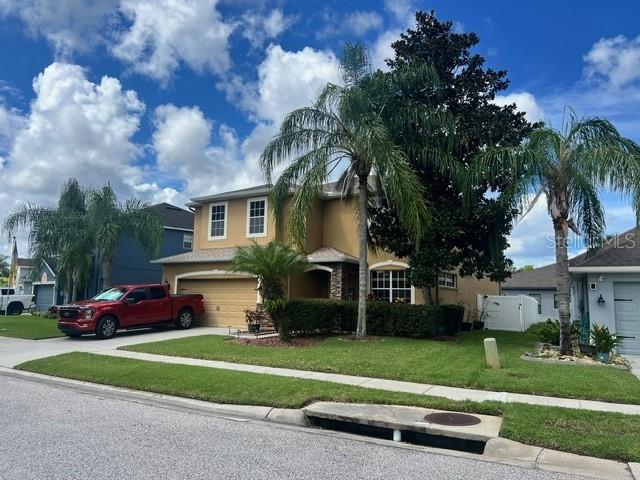 view of front of home featuring a garage and a front lawn