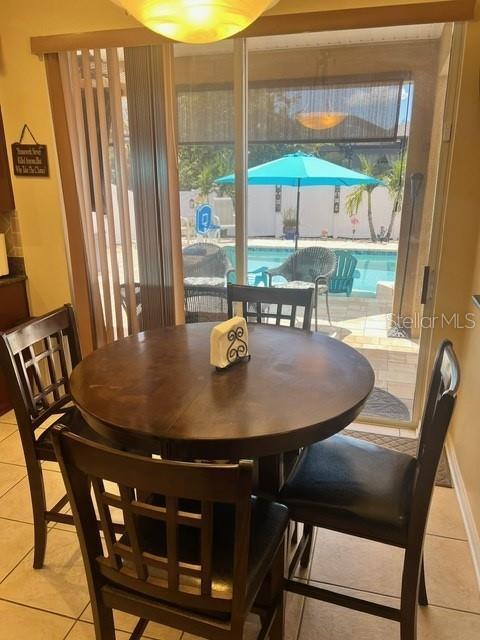 dining room featuring a healthy amount of sunlight and light tile patterned floors