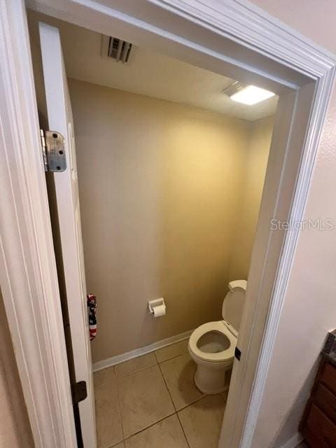 bathroom featuring toilet and tile patterned floors