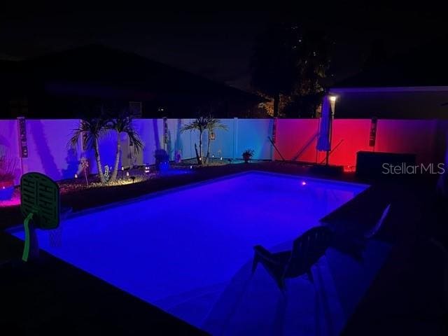 view of pool at night