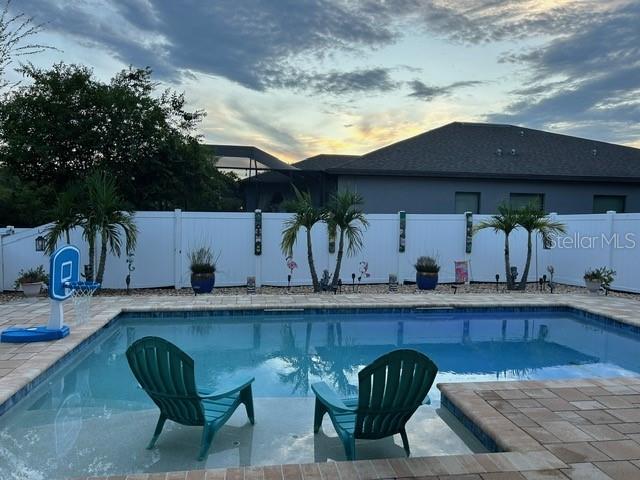 view of pool at dusk