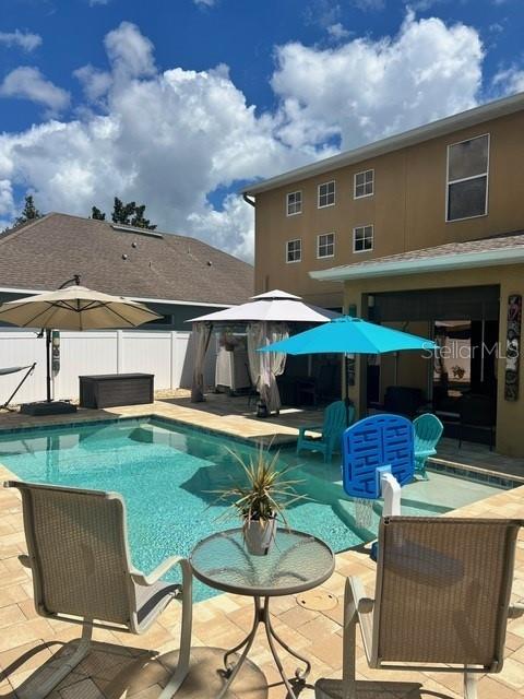 view of swimming pool featuring a patio area