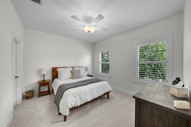 bedroom with light carpet and ceiling fan